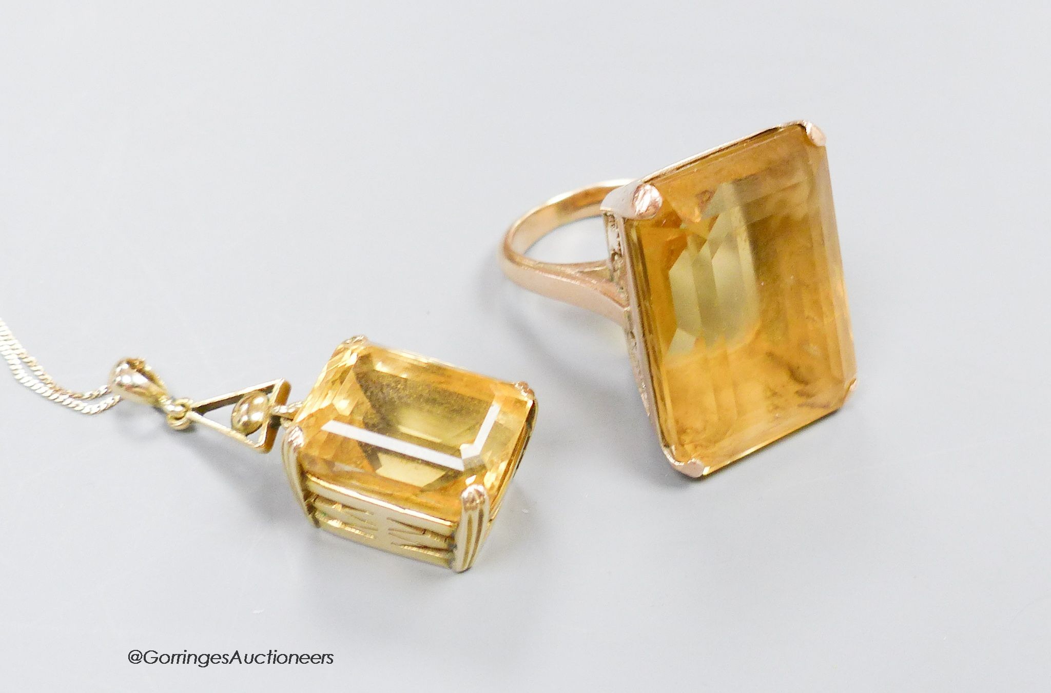 A large yellow metal mounted citrine ring, size M, gross 19.4g. and a similar pendant